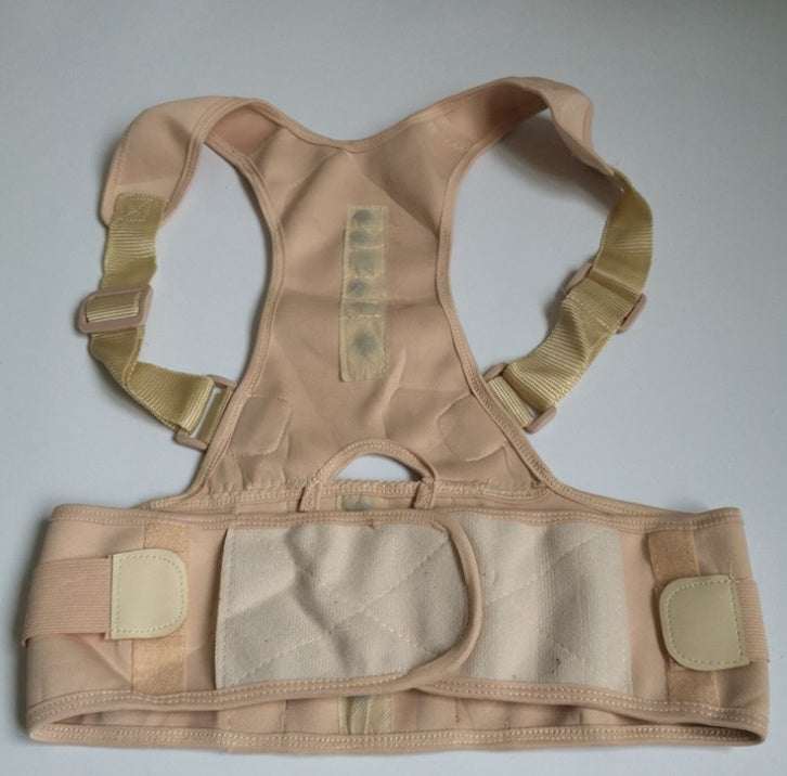 Sitting posture correction belt in flesh color with adjustable straps and padded back support