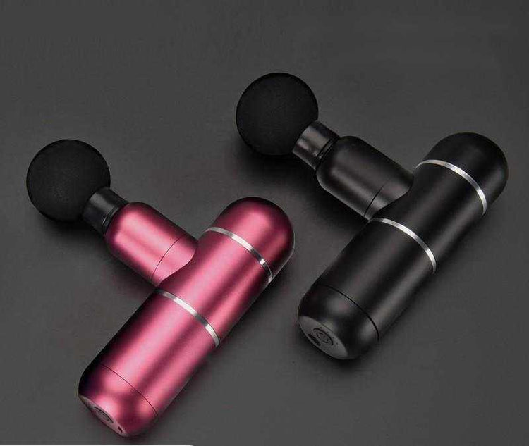 Two mini fascia guns in black and metallic red with round massage heads on a dark background