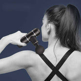 woman using mini fascia gun massage gun on shoulder for muscle relaxation