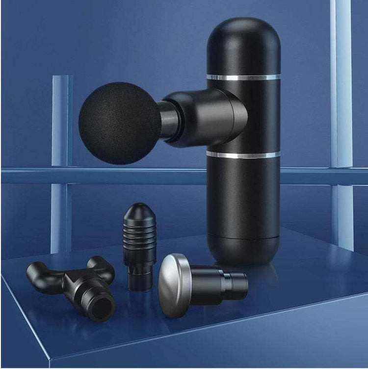 Compact black mini fascia gun massage device with four interchangeable massage heads on blue background