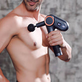 Man using USB rechargeable massage gun with rotatable angle and LED screen on shoulder